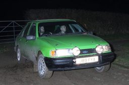 Green Ford Sierra on a South Hams night rally